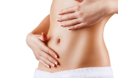 Woman with contoured abdomen placing hands on belly